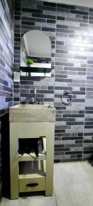 a bathroom with a sink and a mirror at CABAÑA M&M in El Calafate