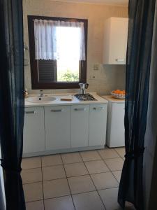 a kitchen with a sink and a window at Apartmani Mirjana Umag in Umag