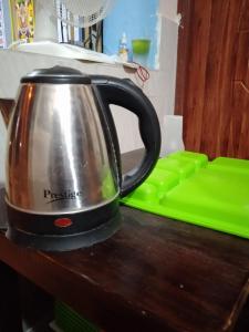 a tea kettle sitting on top of a kitchen counter at Paradise corner in Puducherry