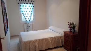a small bedroom with a bed and a window at Holiday Paraiso in Sant Antoni de Calonge