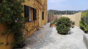 a stone walkway next to a building with flowers at Holiday Paraiso in Sant Antoni de Calonge +15 photos