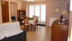 a kitchen and dining room with a table and chairs at Gîte La sapinière in Saint-Martin-de-la-Mer
