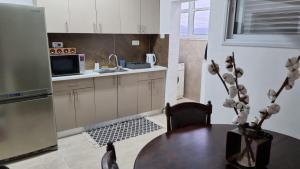 a kitchen with a table and a sink and a microwave at KING of the dead sea by CROWN in Neve Zohar