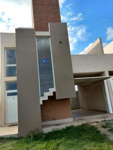 a house with a staircase on the side of it at Alquileres Temporarios Villa María in Villa María