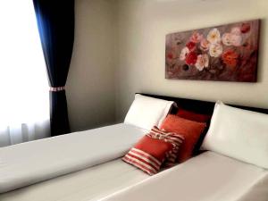 a white couch with pillows and a painting on the wall at RELAX Apartments in HASKOVO, Apt1 in Haskovo