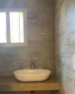a white sink in a bathroom with a window at Hostel Avetaia in Santa Rosa de Calamuchita +33 photos