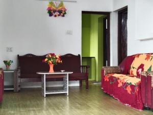 a living room with a couch and a table at KODAIKANAL HOME STAY in Kodaikānāl