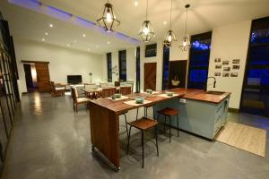 a kitchen and dining room with tables and chairs at The River Bank, Jinja in Jinja