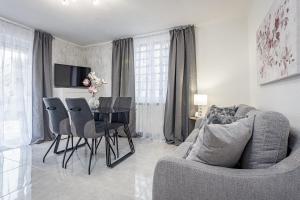 a living room with a table and chairs and a couch at Luxury Apartments Gina in Rovinj