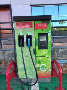 a gas station with a pay phone in front of a building at Seville Luxury Apartment Parking Opcional in Bormujos