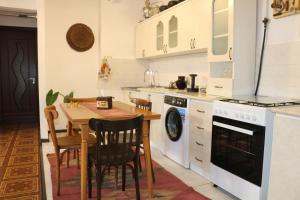 a kitchen with a wooden table and a dining room at Apartment 11 in Gyumri