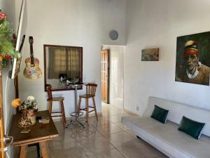 a living room with a couch and a table at CASA BUZIOS PRAIA RASA in Búzios