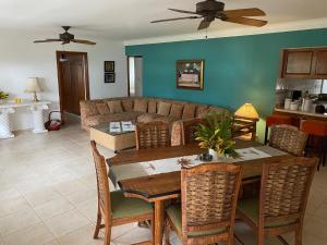 a living room with a table and a couch at Los Corozos Apartment G1 Guavaberry Golf & Country Club in Juan Dolio