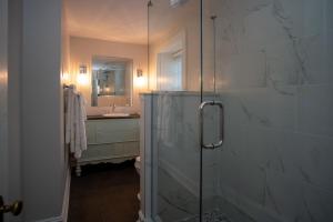 a bathroom with a glass shower and a sink at Allenberry Resort in Carlisle