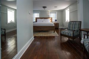 a bedroom with a bed and a couch and a chair at Allenberry Resort in Carlisle
