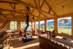 a large living room with a fireplace in a house at Estancia Bonanza in El Chalten