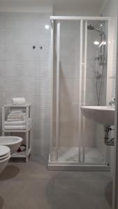 a bathroom with a shower and a sink and a toilet at Azzurramare Bed & Breakfast in Grottammare