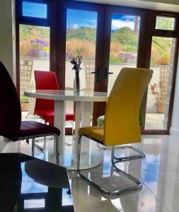 a table and four chairs in a room at Muckruss Lodge Clonakilty An Oasis of Tranquility in Clonakilty