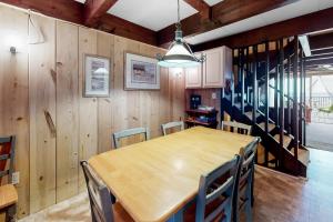 a dining room with a wooden table and chairs at White Sands Village 27 in Ocean City