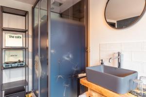 a bathroom with a sink and a mirror at Hotel De Werf in Den Helder