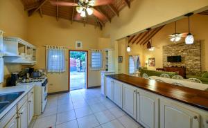 a kitchen with a counter top and a dining room at Casa Chiesa in English Harbour Town