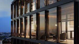 a building with large windows with a view of a city at Prestige Jacuzzi Apartment by LIUKSAI in Klaipėda