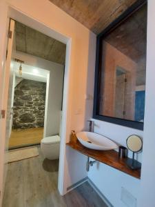 a bathroom with a sink and a mirror at CASA DO SOL in Jardim do Mar