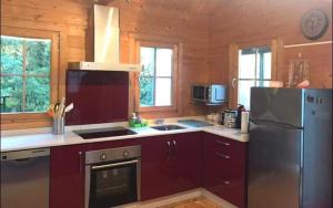 a kitchen with a stainless steel refrigerator and a stove at Cabana Monte do Castro in Porto do Son