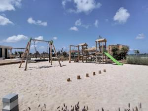 an empty playground in the sand on a beach at 'Dreamy sunsets' - appartement met 3 slaapkamers in Playa Honda
