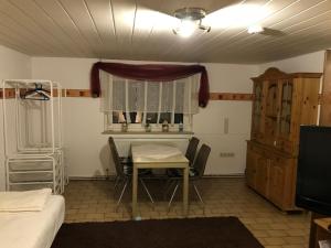 ein Raum mit einem Tisch und Stühlen und einem Fenster in der Unterkunft Ferienwohnung Sandner in Porta Westfalica
