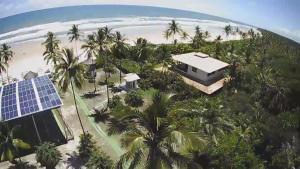 an aerial view of a house with solar panels next to a beach at Ilhéus North Residence Danilo in Uruçuca