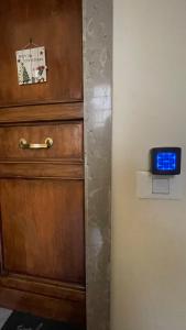 a clock on a wall next to a wooden cabinet at GUEST HOUSE KINGA CAVOUR in Florence