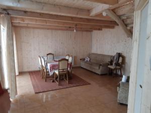 a living room with a table and chairs and a couch at Cabana Cristalul din Apuseni in Ciuruleasa