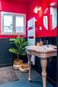 a bathroom with a sink and a potted plant at LoveSparadise - Suite L'élixir in Chessy