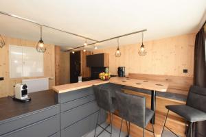 a kitchen with a counter and a table and chairs at Haller´s Posthaus in Riezlern