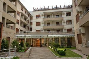 an external view of a building with a courtyard at Apolon Spa in Vrnjačka Banja