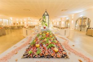 a large pile of food on a table in a building at HOTEL BARONE DI MARE in Torre dell'Orso