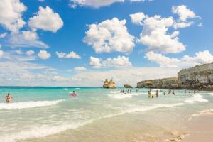 a group of people in the water at the beach at HOTEL BARONE DI MARE in Torre dell'Orso