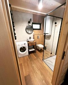 a bathroom with a washing machine and a sink at Aparthouse Siemiany in Siemiany +51 photos
