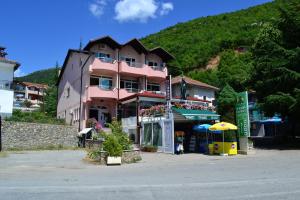 a pink building on the side of a mountain at Villa D&L in Ohrid