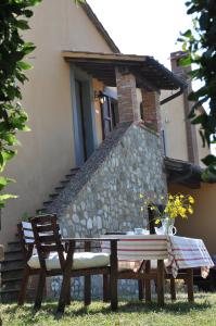 a picnic table and bench in front of a building at Campocane Oaks in Trevinano