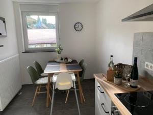 a small kitchen with a table and chairs and a window at Spatzennest am Taubenhaus Residenz Moselliebe in Traben-Trarbach +14 photos