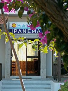 um sinal de hotel panama na frente de um edifício em Ipanema Hotel em Tigaki
