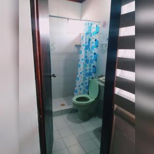 a bathroom with a green toilet and a shower at Cabaña Midas Rodadero in Santa Marta