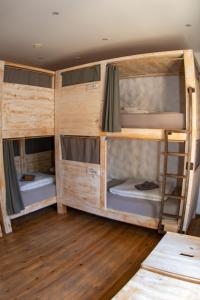a group of bunk beds in a room at Wellenkind Surfschool in La Pared