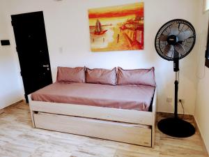a bedroom with a bed and a fan at Condominio Plaza Italia - Cochera gratis in Mar del Plata