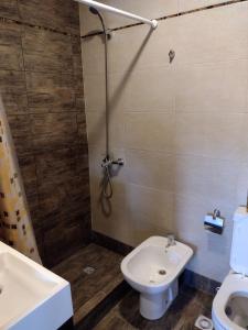 a bathroom with a shower and a toilet and a sink at Condominio Plaza Italia - Cochera gratis in Mar del Plata