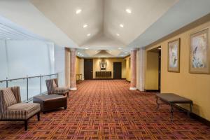 a hallway with two chairs and a waiting room at Crowne Plaza Englewood by IHG in Englewood