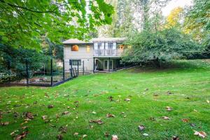 a large yard with a house with a fence at Country Living in the City. in Campbell River