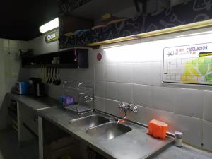a kitchen counter with a sink in a kitchen at Hostel de la Plaza in Miramar +39 photos